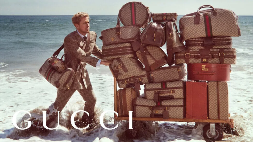 gucci ad with man pushing a bag trolley