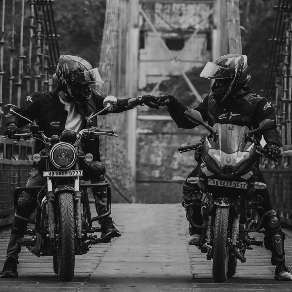 review marketing with two motorist fist bumping each other