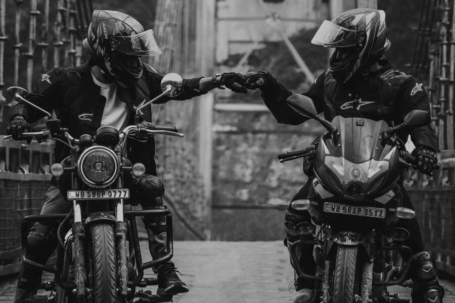 review marketing with two motorist fist bumping each other